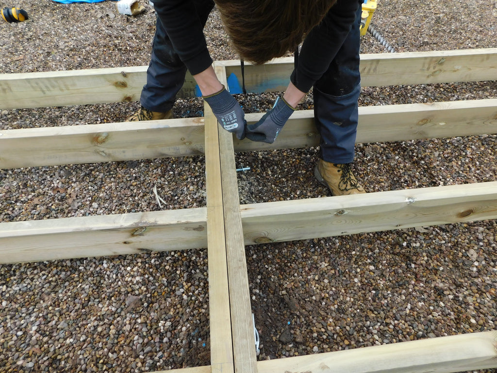 Galvanised ground screws for a garden building base
