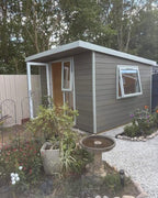 Suresheds composite garden room in taupe composite cladding with white uPVC door and top-opening window