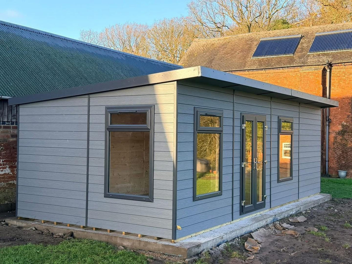 Suresheds Kingsdale Contemporary composite garden room in light grey composite cladding with anthracite uPVC French doors and windows