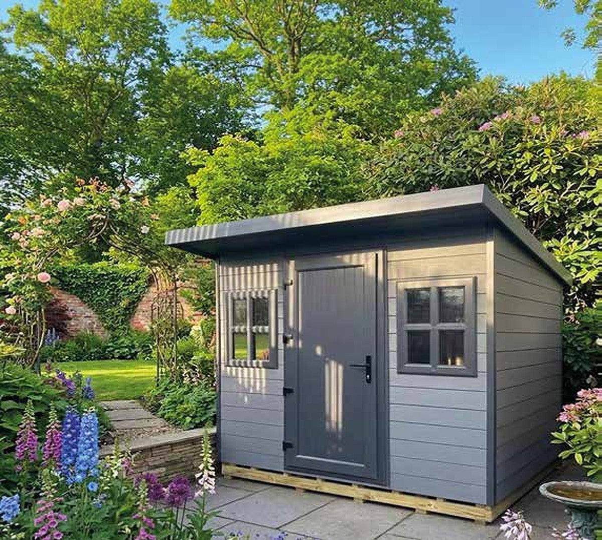 Composite Settle Cottage by Suresheds – grey composite cladding, pent roof, UPVC door and Georgian windows