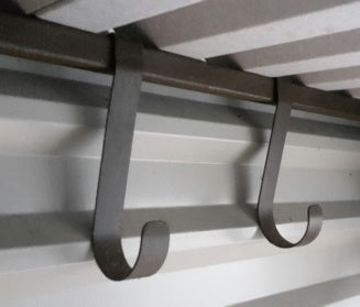 Lifelong steel storage hooks fitted inside a steel shed