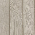 Close-up of the factory-primed LP SmartSide embossed wood-grain exterior before painting