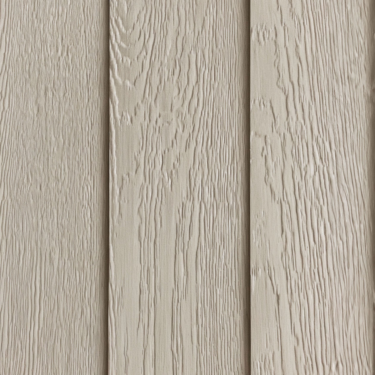 Close-up of the factory-primed LP SmartSide embossed wood-grain exterior before painting